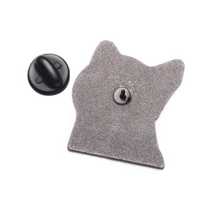 Macro detail of the metal cat badge back featuring a sharp pin and black rubber clutch