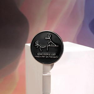 Macro detail of enamel pin with 'Some people just need a pat on the back' quote