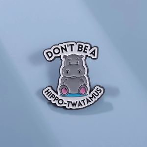 Creative hippo enamel pin with Don't Be A Hippo-twatamus text on blue background