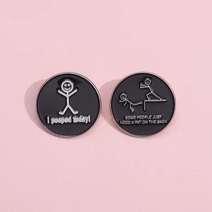 Macro detail of round enamel pins with humorous stick figure designs and English text