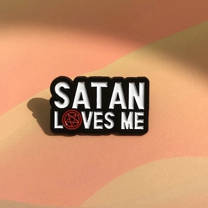 Satan Loves Me enamel pin badge with pentagram star on decorative matte background