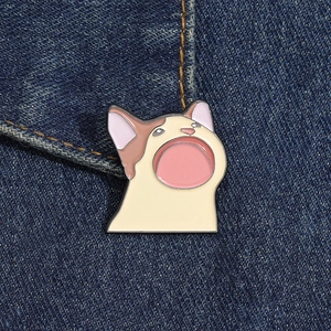 Close-up of Pop Cat enamel pin on blue denim jacket featuring cartoon gaping mouth design
