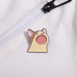 Detailed view of creative Pop Cat enamel pin attached to a white canvas texture bag