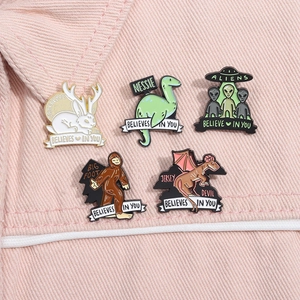 Detailed close-up of colorful cartoon enamel pins set on pink denim jacket pocket