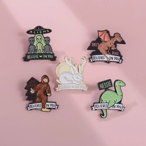 5-piece mystical creature enamel pin set featuring Bigfoot, UFOs, and Nessie motifs