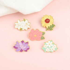 5-piece flower enamel pin set with sunflower and lily designs on pink background