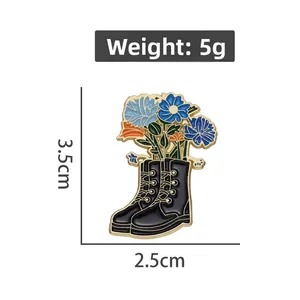 Detailed view of colorful lily flower enamel pin in a black boot with size dimensions