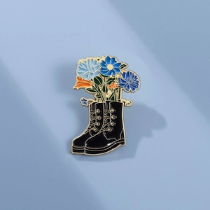 Creative black leather boot brooch with colorful blue flowers and golden enamel details