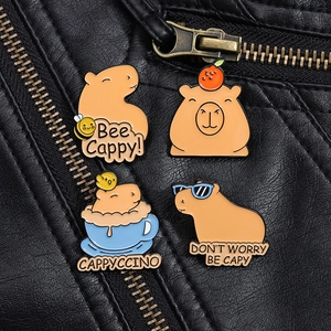 Detailed view of four cute Capybara enamel pins on a black leather jacket texture