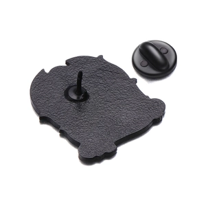 Detail of matte black metal brooch back with secure needle and rubber butterfly clutch