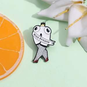 Creative enamel pin featuring walking legs with Miss Fresno sash and crown on green background