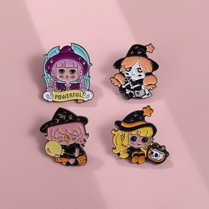 Detailed view of four cute enamel witch pins with colorful hair and magical icons