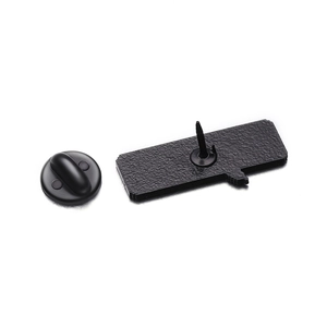 Macro detail of the matte black metal brooch back with single pin and secure clutch
