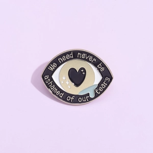 Broche œil en émail avec texte 'We need never be ashamed of our tears' sur fond violet