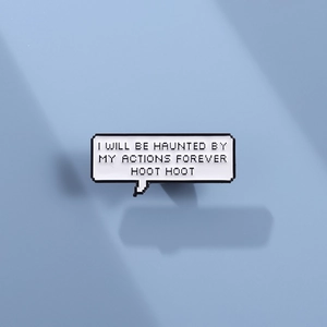 Close-up of pixel speech bubble enamel pin with quote and retro aesthetic design