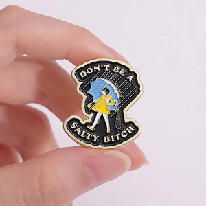 Cartoon enamel pin of girl with umbrella and funny slogan Don't Be A Salty Bitch
