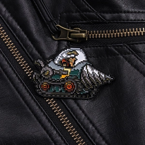 Close-up of retro pixel art enamel pin showing game tank on a black leather jacket