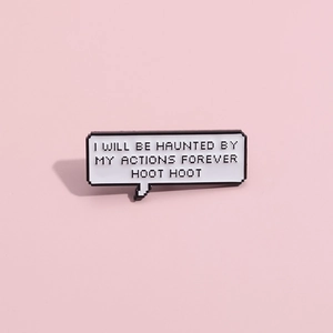 Detail of pixel speech bubble brooch with text I will be haunted by my actions forever