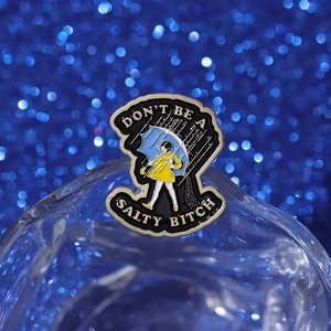 Creative girl in yellow raincoat enamel pin with Don't Be a Salty Bitch quote