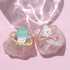 Cute space themed enamel brooches featuring cartoon shark and creature with golden rings