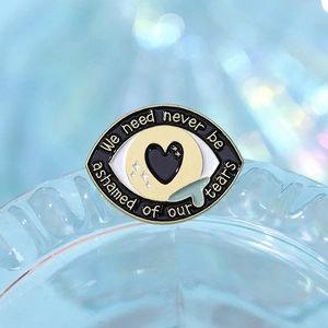 Broche en émail forme œil avec citation larmes sur base en cristal bleu chic