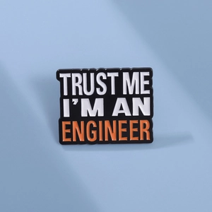 Funny black enamel pin for engineers featuring Trust Me I'm An Engineer text