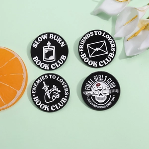 Set of four gothic enamel pins featuring horror and literary themes on metal alloy badges