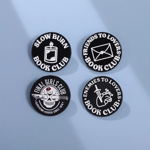 Set of four black and white enamel pins with horror movie and book trope themes