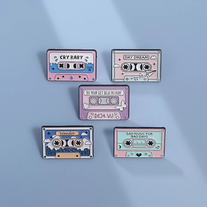 Set of five retro cassette tape enamel pins in pastel colors with creative illustrations
