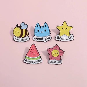 Detail showing five colorful enamel pins with motivational quotes like Good Job and Well Done