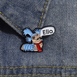 Labyrinth movie worm enamel pin with Ello speech bubble on blue denim jacket