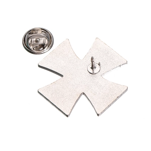 Detail of silver metal cross brooch back with butterfly clutch and matte texture
