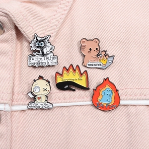 Detailed view of five unique funny meme enamel pins on a pink denim jacket collar