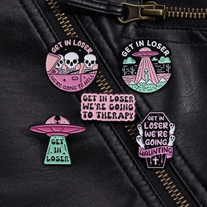 Detailed view of 5-piece punk enamel pins on a black leather jacket featuring UFO designs