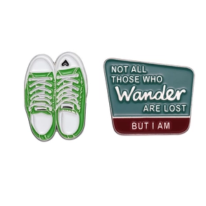 Enamel pins set with green canvas sneakers and Not All Those Who Wander Are Lost quote