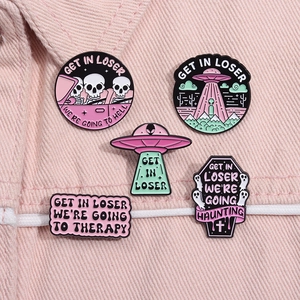 Set of 5 punk enamel pins featuring aliens, UFOs, and pink skulls on denim jacket