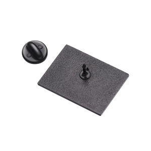 Macro view of matte black metal brooch backing with a secure butterfly clutch pin