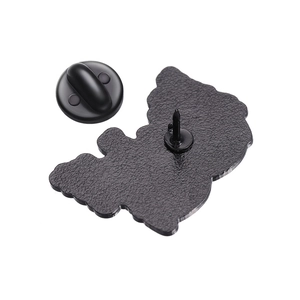 Macro shot of minimalist metal brooch back featuring black rubber clutch and matte texture