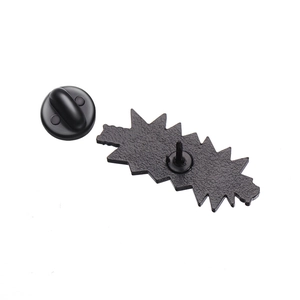 Detail view of video game pin back featuring black metal base and rubber clutch fastener