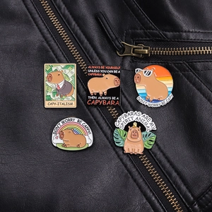 Detailed close-up of cute Capybara enamel pins on a black leather jacket collar