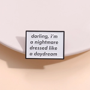 Creative enamel pin badge featuring a nightmare dressed like a daydream slogan in white
