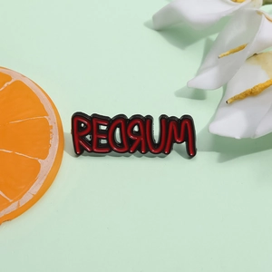 Enamel Redrum pin brooch with horror movie letter design on light green background