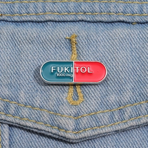Creative FUKITOL capsule enamel pin on blue denim jacket for medical humor gift
