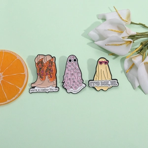 Three-piece set of floral cowboy boots and ghost enamel pins with pop culture lyrics