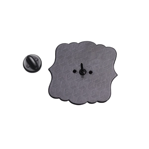 Macro view of wave-edged metal brooch backing and black rubber butterfly clutch pin