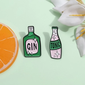 Cartoon enamel brooch set featuring green Gin and pink Tonic bottle designs with glitter