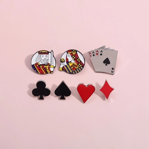 Set of 7 colorful poker themed enamel pins with King Queen and Suit designs on pink surface