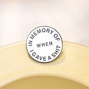 Minimalist enamel pin badge featuring In Memory Of When I Gave A Shit text design