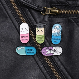 Detailed close-up of five colorful enamel pill brooches pinned on a black leather jacket