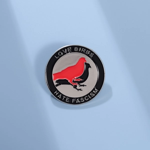 Enamel lapel pin with Love Birbs and Hate Fascism slogan on light blue background